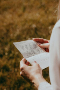 A person reading a hand written letter